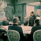 Keine lesbaren Texte. Eine Gruppe von Männern in Uniformen sitzt um einen Tisch in einem eleganten Raum.