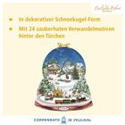 "In dekorativer Schneekugel-Form. Mit 24 zauberhaften Wandelmotiven hinter den Türchen." Illustration eines Winterdorfs.