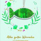 „Alle guten Wünsche zur Erstkommunion“ in goldener Schrift. Grüner Paillettenfisch mit Blatt- und Fischmotiven.