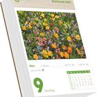 "Gartenzeit 2027", "März", "9 Montag". Illustration: Bunte Frühlingsblumenwiese. Logo oben links. Kalenderblatt mit Datum.