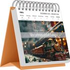 Kalender mit Text: "Mögen dir immer die richtigen Worte begegnen, wenn du sie brauchst". Modellzug im Schnee.