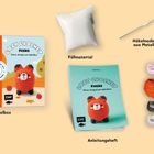 "Häkelbox", "Füllmaterial", "Häkelnadel aus Metall", "Sicherheitsaugen", "Cozy Crochet Fuchs", "Anleitungsheft", "Garne".