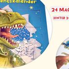 24 MAGNETE, HINTER 24 TÜREN. Illustration: Grüner Dino mit Weihnachtshut, davor wird ein Ankylosaurus-Magnet gehalten.