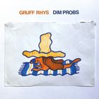 Text: "GRUFF RHYS", "DIM PROBS". Illustration eines Hundes auf einem gestreiften Tuch mit großem, gelbem Hut darauf.