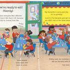 In einem bunten Klassenzimmer sitzen Kinder an Tischen und essen verschiedene Gerichte zum Mittagessen.