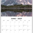 Juni 2027 Kalender, Foto von Bergen im Hintergrund. Pastellrosa Himmel, schneebedeckte Gipfel und Spiegelung im Wasser.
