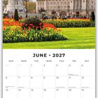 Juni 2027 Kalender mit Bild eines Gebäudes und einer Statue in einem bunten Garten unter blauem Himmel.