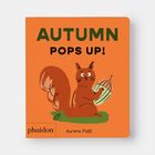 Text: "AUTUMN POPS UP!" Illustration: Ein rotes Eichhörnchen hält einen Kürbis auf orangefarbenem Hintergrund.