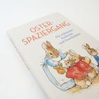 "Osterspaziergang: Die schönsten Gedichte und Geschichten" steht oben. Illustration mit Hasenfamilie in Kleidung.