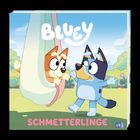 Illustration: "BLUEY" oben, "SCHMETTERLINGE" unten. Zwei Hunde spielen im Freien, einer schaukelt, der andere tanzt.