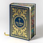 "Die Bibel nach Luther" steht in goldener Schrift auf einem dunkelblauen, reich verzierten Einband mit floralen Mustern.