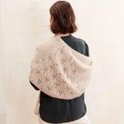 Eine Person von hinten betrachtet, trägt ein schwarzes Oberteil und einen gestrickten, hellen Schal mit Lochmuster.