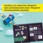 Schnelle 10-Minuten-Projekte, komplexere Deko für Anlässe. 
Papierflugzeug und Buch mit DIY-Anleitung vor Wolkenhintergrund.