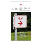 Kalenderblatt für Mai. Oben ein Fahrrad-Wegweiserschild mit Pfeil. Text: "Manchmal steht die Welt Kopf, damit wir die Perspektive ändern!"