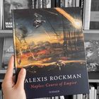 „ALEXIS ROCKMAN“ und „Naples: Course of Empire“ steht auf einem Buchcover. Ein Gemälde zeigt eine düstere Landschaft.