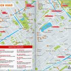 Ein Stadtplan von Den Haag mit rot hervorgehobenen Sehenswürdigkeiten wie "Chinatown" und "Mauritshuis".