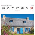 21. Woche, 21.5.–20.6., Fronleichnam. 
Steinhaus mit blauem Dach und Fensterläden, blühende Pflanzen davor.