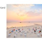 Perfektes Plattdeutschland: Ostfriesland. Strand mit bunten Strandkörben, Menschen, Sonnenuntergang, ruhige See.