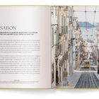 "LISSABON" steht in großen Buchstaben. Daneben eine Straßenansicht mit einer gelben Straßenbahn, die eine steile Straße hinunterfährt.