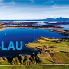 "BLAU" in großen Buchstaben. Panorama eines Sees mit grünen Ufern und weiter Landschaft.