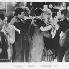 Besetzung: Brigitte Bardot in "Please, Not Now." Mehrere Paare tanzen eng umschlungen in stilvoller Abendgarderobe.