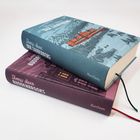 Zwei Bücher von Thomas Mann: "Buddenbrooks" und "Der Zauberberg", mit farbigen Illustrationen und Lesebändern.