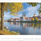 Kalender zeigt Oktober mit Bild von Regensburg. Herbstliche Bäume am Fluss, Altstadt und Dom im Hintergrund.