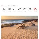 Kalenderwoche 29 im Juli: 19-25. Parque Natural de Corralejo, Fuerteventura. Ein Sandstrand mit Pflanzen, Wasser und Felsen.