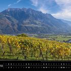 Text: "Blick von Aspen oberhalb von Eschen auf das Drei Schwestern Massiv und ins Liechtensteiner Oberland." Kalender mit Weinbergen im Vordergrund, Bergen im Hintergrund.