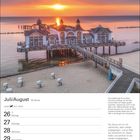 Juli/August, 30. Woche. Löwe: 23.7.–22.8. Text über Sonnenaufgang an der Seebrücke Sellin, Strandkörbe am Sandstrand, Sonnenuntergang im Hintergrund.