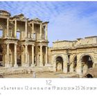 "Ephesus", darunter Kalender mit hervorgehobener Zahl "12". Zeigt antike, steinerne Ruinen mit Säulen und Bögen.
