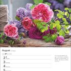 August, 31. Woche, Löwe ♌ 23.7.–22.8. Text: Zitat von Sylvia Plath über Gartenarbeit. Rosen und Flieder auf Holztisch.