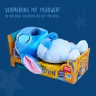 Text: "Verpackung mit Mehrwert. Die Box dient gleichzeitig als Bett für Stitch." Plüschfigur in Verpackung als Bett.