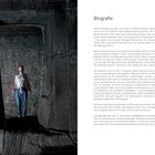 Links steht eine Person in einem großen, rechteckigen Steintunnel. Rechts ist der Text "Biografie".