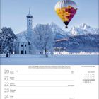 Kalender mit den Daten 20. bis 26. Dezember 2027. Winterlandschaft mit Kirche und Heißluftballon vor schneebedeckten Bergen.