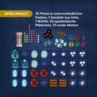 „SPIELINHALT: 35 Pixies, 1 Sanduhr, 1 Würfel, 32 Plättchen, 21 Marker.“ Verschiedene Spielmaterialien in bunten Farben.