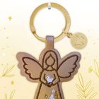„Ich bin immer bei dir“. Schlüsselanhänger in Engel-Form, dekoriert mit goldenen und weißen Details.