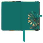 Grünes Notizbuch mit Monstera-Blatt-Illustration unten rechts, liniertem Rand und türkisem Band.