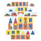 Bunte Kacheln mit Fahrzeugen, Fenstern, Pflanzen, Türen und Dächern in Rot, Blau und Gelb angeordnet wie ein Mosaik.