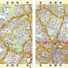 Zwei Stadtpläne nebeneinander zeigen Salford links und Manchester rechts. Straßen, Parks und Flüsse sind detailliert dargestellt.