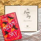 „The Neon Sky“, Alyssa Villaire. Buchcover zeigt fliegende schwarze Vögel vor einem feurigen Hintergrund.