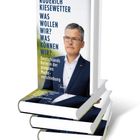 Buchtitel: "RODERICH KIESEWETTER WAS WOLLEN WIR? WAS KÖNNEN WIR?". Cover zeigt einen Mann im Anzug. Stapel von Büchern.