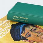 Der Buchrücken in Grün zeigt den Text: "Michael Köhlmeier, Mein privates Glück". Cover mit gemaltem Gesicht.