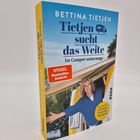 "Bettina Tietjen – Tietjen sucht das Weite: Im Camper unterwegs". Oben eine lächelnde Frau aus einem gelben Camper.