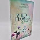 Der Text auf dem Cover lautet: "BIANKA BEHREND, WILD FLOWER Whispers, ROMAN, everlove". Darunter sind bunte Blumen gezeichnet.