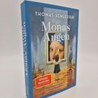 Titel: "Monas Augen" von Thomas Schlesser. Darunter: "SPiEGEL Bestseller". Mädchen blickt auf ein Gemälde.