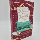 "Delivered with a Winter's Kiss", "24 Tage zum Verlieben Adventskalender", dekoriert mit Schneeflocken und einer Schreibmaschine.