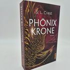 Buchtitel: "Phönix Krone" von S.L. Crest. Illustration eines goldenen Phönix auf dunklem Hintergrund.