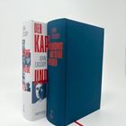 Zwei Bücher: „John Cassidy: Der Kapitalismus und seine Kritiker“. Eines mit weißem Schutzumschlag, eines dunkelblau.