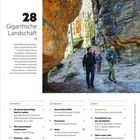 28 Gigantische Landschaft. Menschen wandern durch Felsformationen in einer herbstlichen Waldlandschaft.
